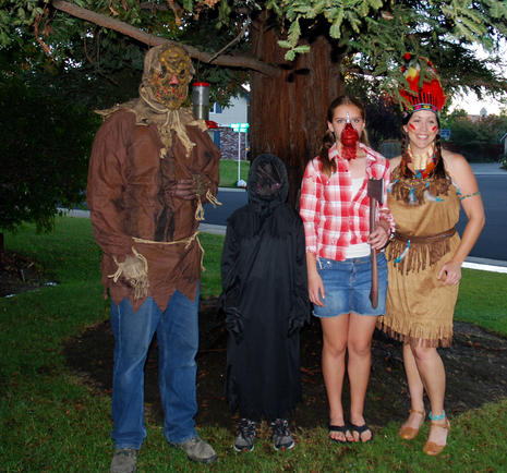 Three people posing in Halloween costumes